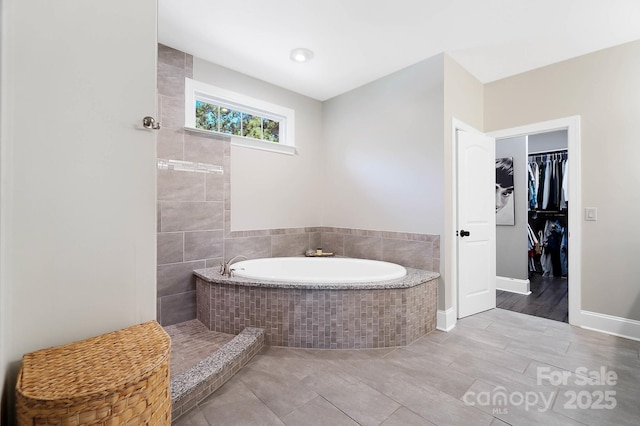 101 Cross Current Ln, Belmont, NC 28012 - bathroom featuring a bath, a walk in closet, and tile patterned floors