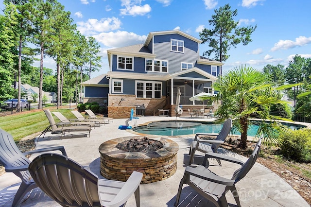 101 Cross Current Ln, Belmont, NC 28012 - back of house with a fire pit, a patio, an outdoor pool, and a sunroom