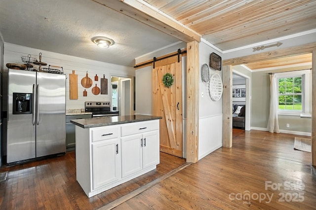 602 Unity St, Fort Mill, SC 29715 - kitchen featuring appliances with stainless steel finishes, a barn door, white cabinets, dark wood finished floors, and dark countertops