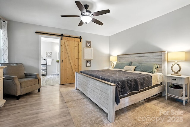 602 Unity St, Fort Mill, SC 29715 - bedroom with a barn door, light wood-style flooring, and a ceiling fan
