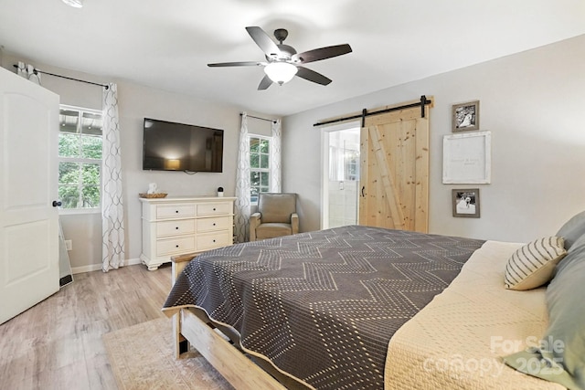 602 Unity St, Fort Mill, SC 29715 - bedroom featuring a barn door, light wood finished floors, multiple windows, and ceiling fan