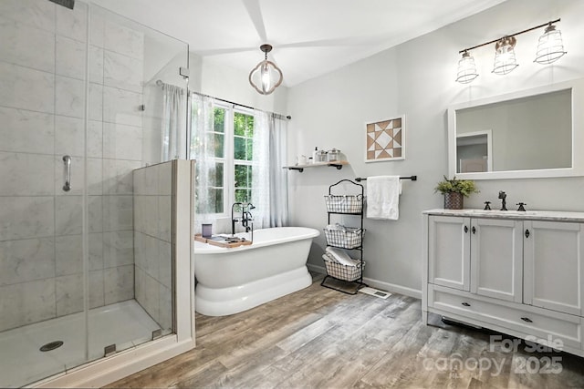602 Unity St, Fort Mill, SC 29715 - bathroom with a stall shower, wood finished floors, a freestanding tub, and vanity