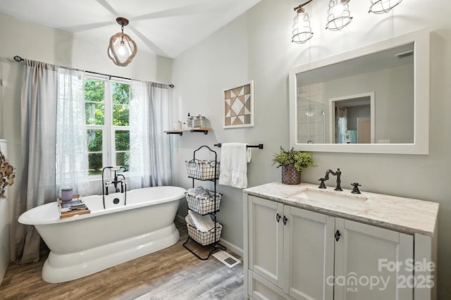 602 Unity St, Fort Mill, SC 29715 - full bath featuring wood finished floors, vanity, a soaking tub, and vaulted ceiling