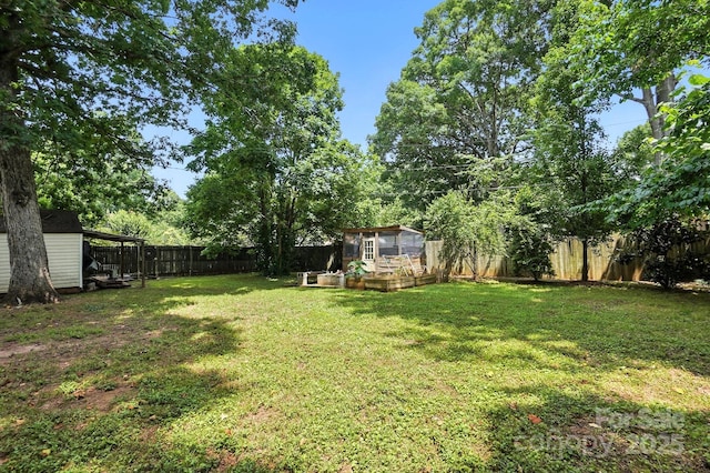 602 Unity St, Fort Mill, SC 29715 - fenced backyard with a vegetable garden and a storage unit