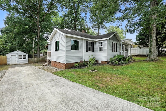 602 Unity St, Fort Mill, SC 29715 - view of front of property featuring an outbuilding, a chimney, a shingled roof, and concrete driveway