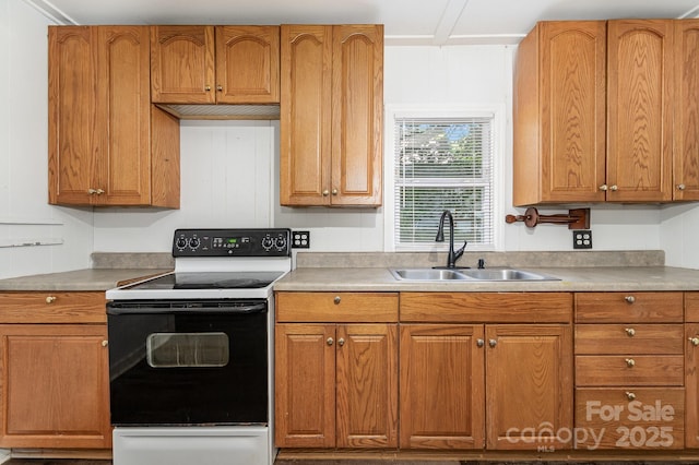 1224 Hollywood Ter, Albemarle, NC 28001 - kitchen with range with electric cooktop, light countertops, and brown cabinets