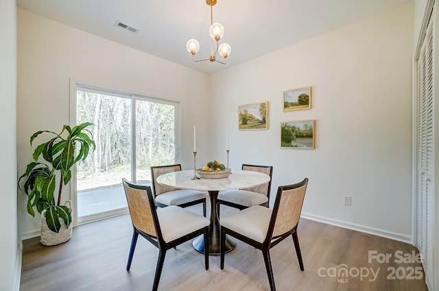 709 Catawba St, Lincolnton, NC 28092 - dining room featuring wood finished floors and a chandelier