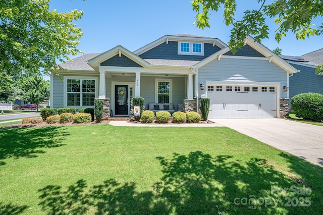 658 Gardenbrook Trl, Belmont, NC 28012 - craftsman-style house with an attached garage, driveway, a front lawn, stone siding, and a porch