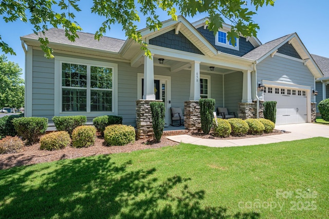 658 Gardenbrook Trl, Belmont, NC 28012 - craftsman-style house with an attached garage, a front lawn, driveway, covered porch, and a shingled roof