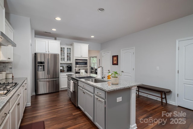 658 Gardenbrook Trl, Belmont, NC 28012 - kitchen with appliances with stainless steel finishes, tasteful backsplash, an island with sink, dark wood-type flooring, and recessed lighting