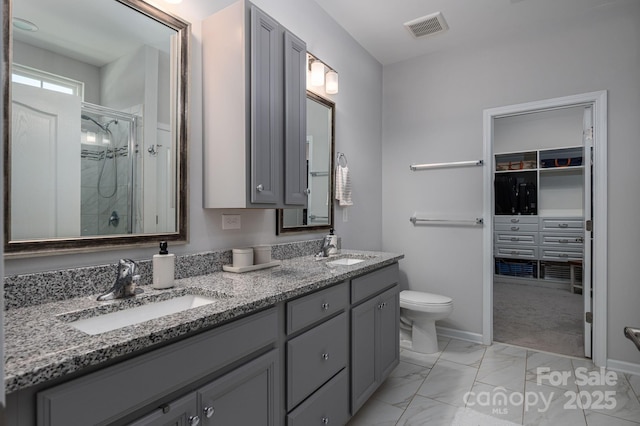 658 Gardenbrook Trl, Belmont, NC 28012 - full bath featuring a shower stall, marble look tiles, double vanity, and a walk in closet