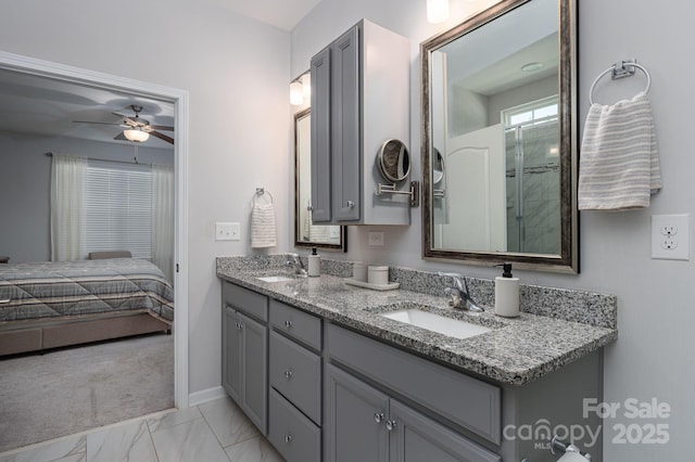 658 Gardenbrook Trl, Belmont, NC 28012 - ensuite bathroom featuring double vanity, marble look tiles, and ceiling fan