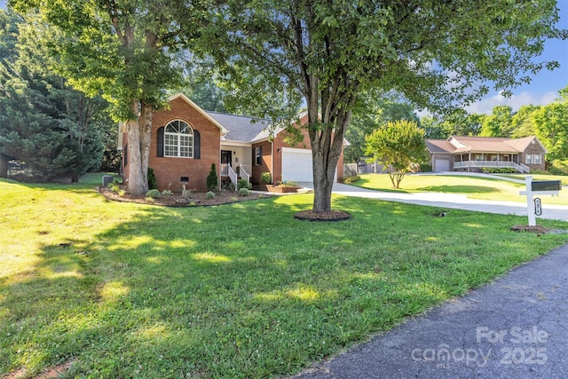 5476 Twelve Oak Ln, Conover, NC 28613 - ranch-style home with concrete driveway, brick siding, a front lawn, and an attached garage
