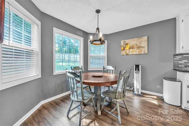 5476 Twelve Oak Ln, Conover, NC 28613 - dining space featuring a textured ceiling, wood finished floors, and a chandelier
