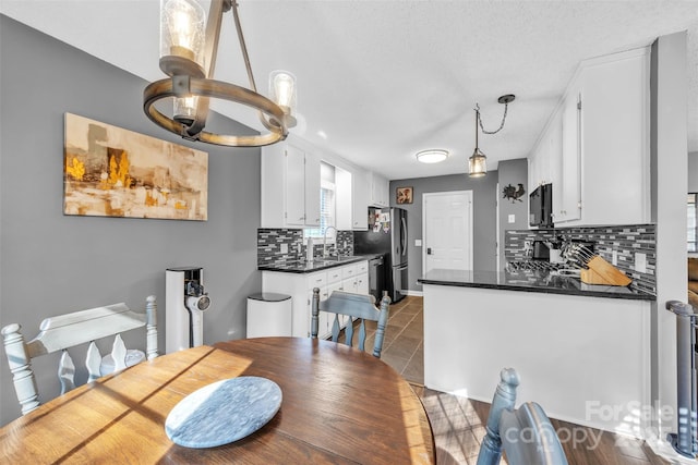 5476 Twelve Oak Ln, Conover, NC 28613 - dining area with tile patterned floors, a chandelier, and a textured ceiling