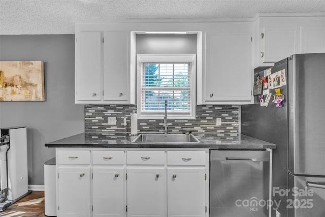 5476 Twelve Oak Ln, Conover, NC 28613 - kitchen with appliances with stainless steel finishes, a textured ceiling, backsplash, and white cabinetry