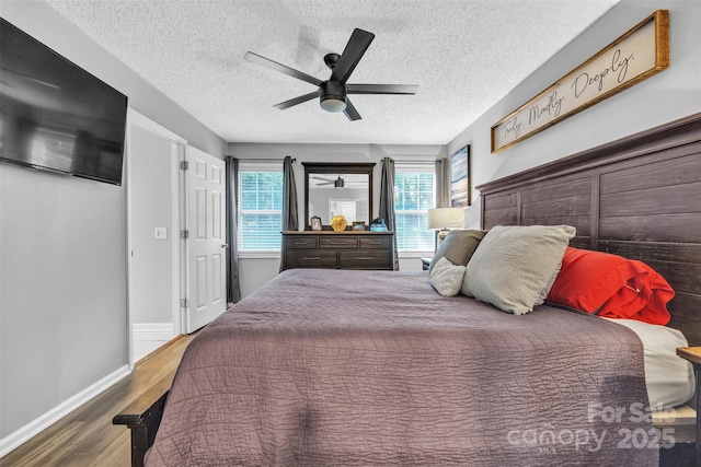 5476 Twelve Oak Ln, Conover, NC 28613 - bedroom with wood finished floors, a textured ceiling, and ceiling fan