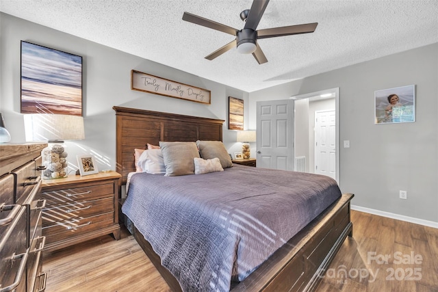 5476 Twelve Oak Ln, Conover, NC 28613 - bedroom with a textured ceiling, light wood-style flooring, and ceiling fan