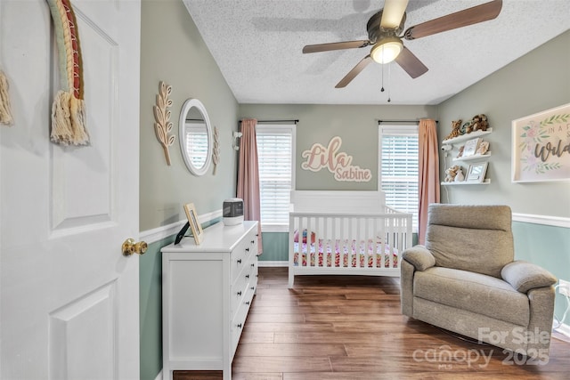 5476 Twelve Oak Ln, Conover, NC 28613 - bedroom with a nursery area, a textured ceiling, wood finished floors, ceiling fan, and wainscoting