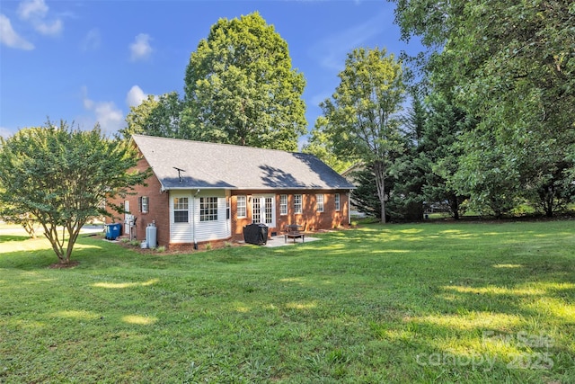5476 Twelve Oak Ln, Conover, NC 28613 - rear view of house with brick siding, a lawn, an outdoor fire pit, french doors, and a patio area