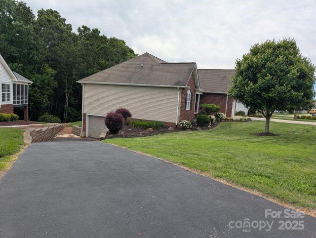 1764 Pipers Ridge Cir NW, Conover, NC 28613 - view of property exterior featuring a yard, an attached garage, and driveway