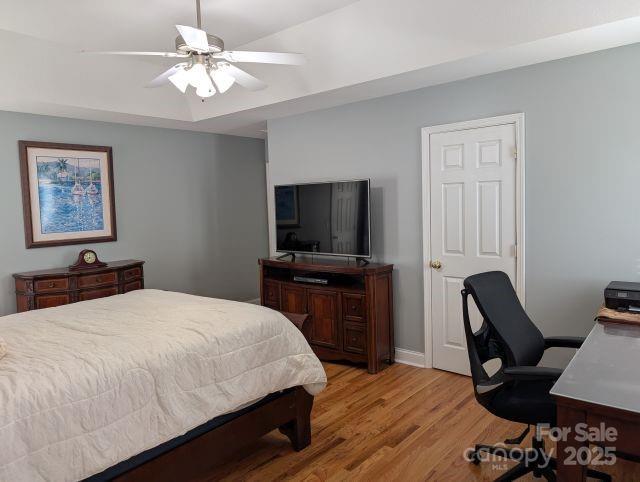 1764 Pipers Ridge Cir NW, Conover, NC 28613 - bedroom with light wood-style flooring, a desk, and a ceiling fan