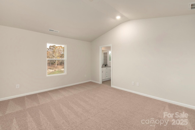 1041 Russell Dr, Winston Salem, NC 27127 - spare room featuring light carpet and lofted ceiling
