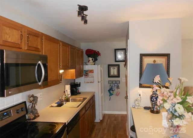 6148 Meadow Rose Ln, Charlotte, NC 28215 - kitchen featuring stainless steel appliances, brown cabinets, light countertops, and dark wood-style floors