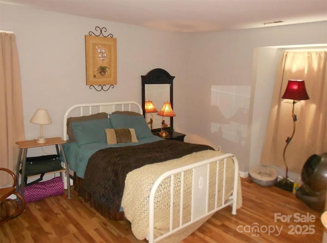6148 Meadow Rose Ln, Charlotte, NC 28215 - bedroom featuring wood finished floors