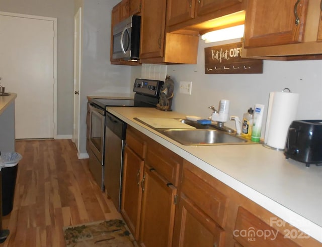6148 Meadow Rose Ln, Charlotte, NC 28215 - kitchen with stainless steel appliances, brown cabinets, light countertops, and light wood-style floors