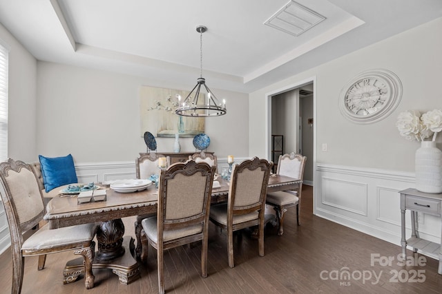 241 Boxelder Rd, Clover, SC 29710 - dining space featuring a raised ceiling, a chandelier, wainscoting, a decorative wall, and wood finished floors