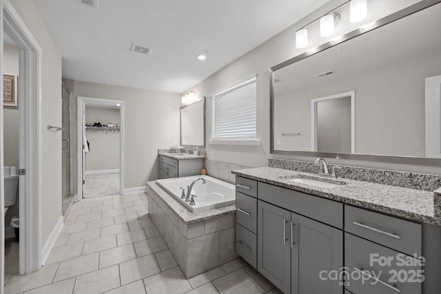 241 Boxelder Rd, Clover, SC 29710 - bathroom featuring two vanities, tile patterned floors, a garden tub, a shower stall, and recessed lighting