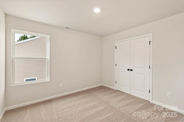 1048 Russell Dr, Winston Salem, NC 27127 - unfurnished bedroom featuring light colored carpet, a closet, and recessed lighting