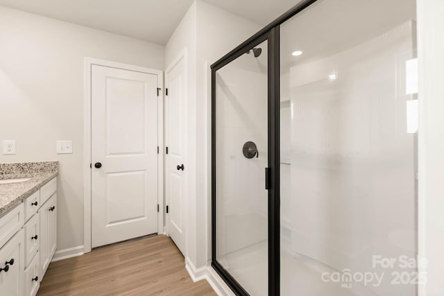 1048 Russell Dr, Winston Salem, NC 27127 - bathroom with wood finished floors, a shower stall, and vanity