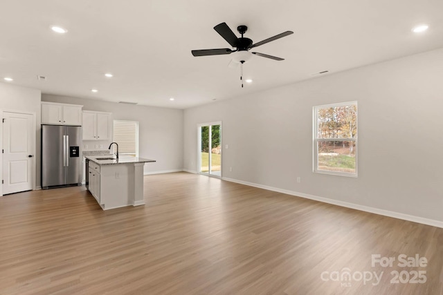1048 Russell Dr, Winston Salem, NC 27127 - unfurnished living room with recessed lighting, light wood-type flooring, and a ceiling fan