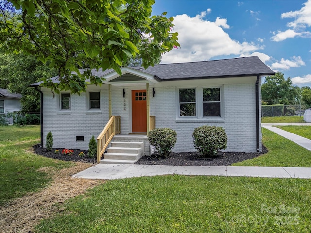 132 Kennedy Ave, Kannapolis, NC 28083 - view of front of house featuring a front lawn, brick siding, and a shingled roof
