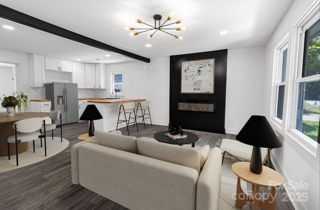 132 Kennedy Ave, Kannapolis, NC 28083 - living area with dark wood-style floors, recessed lighting, beamed ceiling, a chandelier, and a fireplace