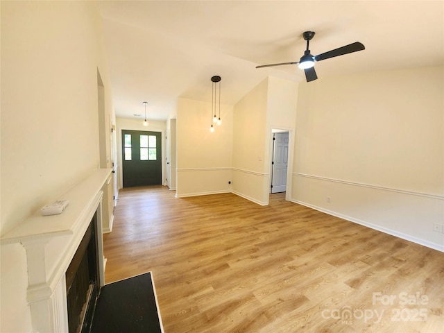 3106 Faircroft Way, Monroe, NC 28110 - unfurnished living room featuring light wood-type flooring, ceiling fan, a fireplace, and lofted ceiling