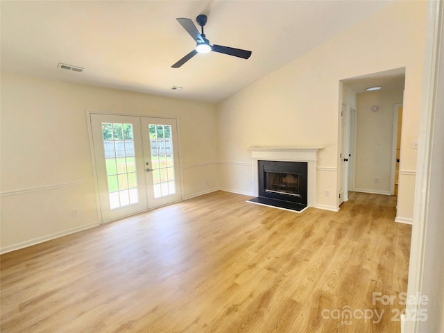 3106 Faircroft Way, Monroe, NC 28110 - unfurnished living room with light wood-style flooring, vaulted ceiling, a fireplace, french doors, and ceiling fan