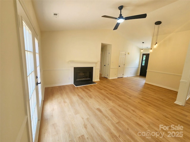 3106 Faircroft Way, Monroe, NC 28110 - unfurnished living room with a fireplace with raised hearth, light wood finished floors, a ceiling fan, and vaulted ceiling