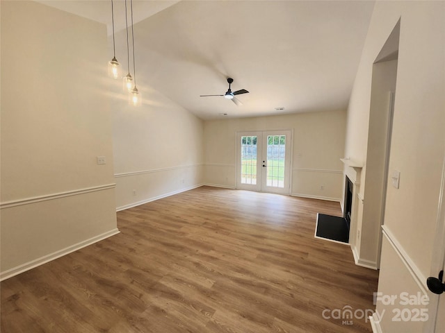 3106 Faircroft Way, Monroe, NC 28110 - unfurnished living room with a ceiling fan, a fireplace, wood finished floors, french doors, and vaulted ceiling