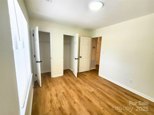 3106 Faircroft Way, Monroe, NC 28110 - unfurnished bedroom with multiple closets and light wood-style floors