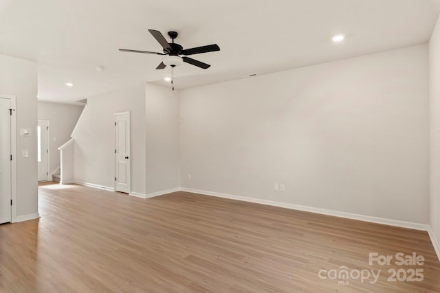 1072 Russell Dr, Winston Salem, NC 27127 - spare room featuring light wood-style floors, ceiling fan, recessed lighting, and stairs