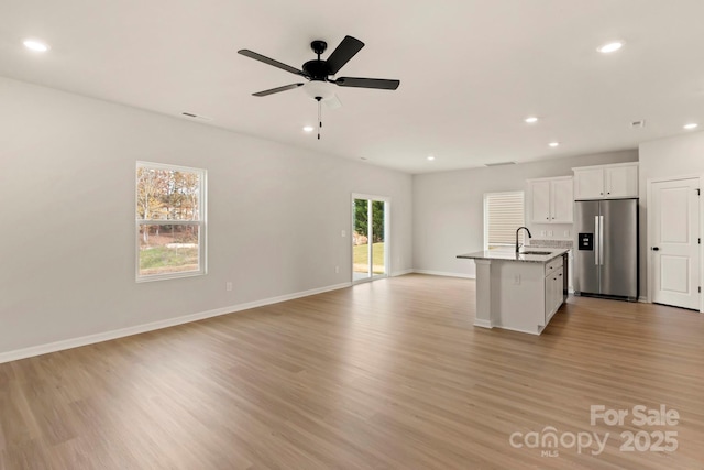 1072 Russell Dr, Winston Salem, NC 27127 - unfurnished living room featuring recessed lighting, light wood-type flooring, and a ceiling fan