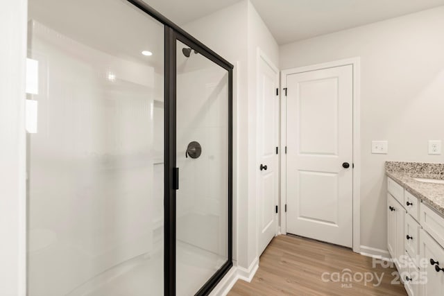 1072 Russell Dr, Winston Salem, NC 27127 - bathroom with vanity, wood finished floors, and a shower stall