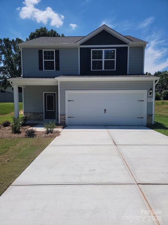 1072 Russell Dr, Winston Salem, NC 27127 - view of front of house with a garage, concrete driveway, covered porch, and stone siding