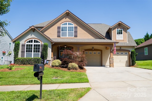 1156 Mckee Farm Ln, Belmont, NC 28012 - craftsman house with a front yard, driveway, roof with shingles, stone siding, and an attached garage