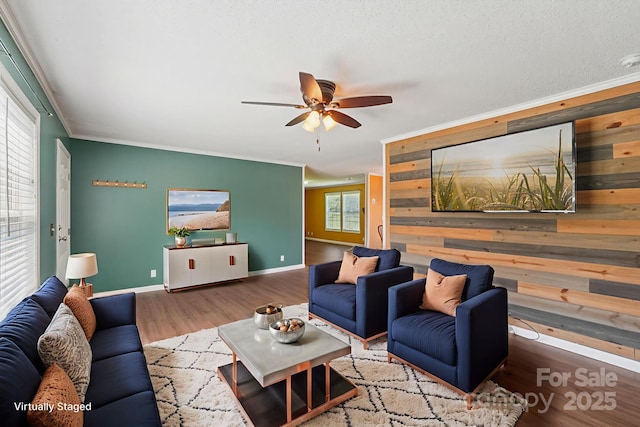 1069 Heather Glen Dr, Catawba, NC 28609 - living area featuring ceiling fan, wood finished floors, ornamental molding, and wood walls