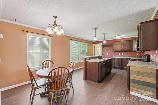 1069 Heather Glen Dr, Catawba, NC 28609 - kitchen with appliances with stainless steel finishes, a textured ceiling, a center island with sink, dark wood-type flooring, and light countertops