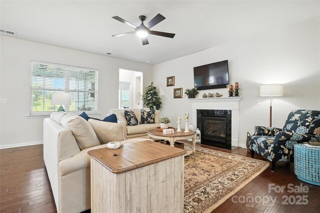 10120 Berkeley Castle Dr, Charlotte, NC 28273 - living room featuring a fireplace with flush hearth, dark wood-style flooring, and ceiling fan